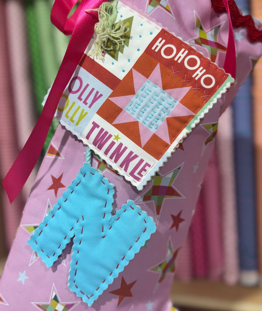 Decorative Christmas stocking with colorful text and patterns